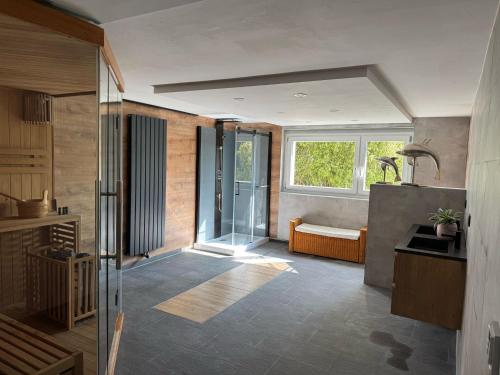 a room with a bathroom with a shower and a window at Kaja 2, Ferienwohnung mit eigener Sauna in Möhnesee