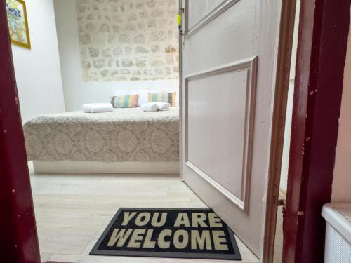 a door with a sign that says you are welcome at Cozy studio Lučić 1 i 2 in Dubrovnik