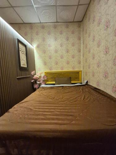 a bedroom with a bed with a laptop on it at Airi Homestay in Suvarnabhumi Airport