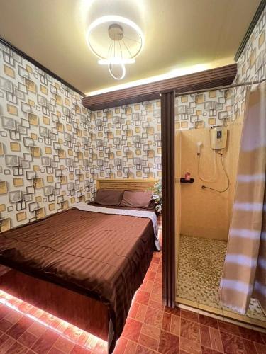 a bedroom with a bed in a room with a shower at Airi Homestay in Suvarnabhumi Airport