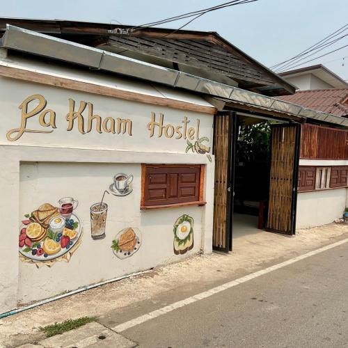 a restaurant with a sign on the side of a building at Pakham hostel in Pai