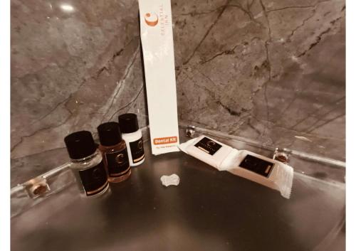three bottles of essential oils sitting on a table at Celestial Inn in Prayagraj