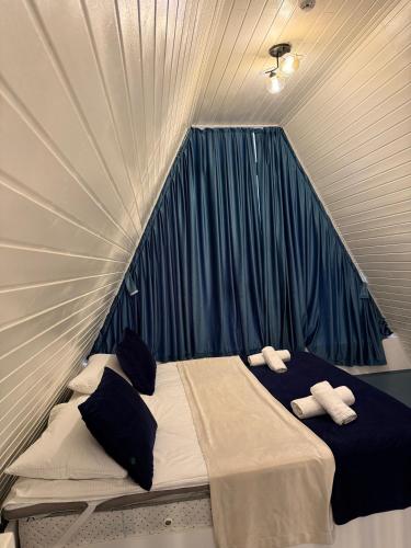 a bed in a tent with two pillows on it at Qızıl Farel (Ailəvi İstirahət Mərkəzi) in İsmayıllı