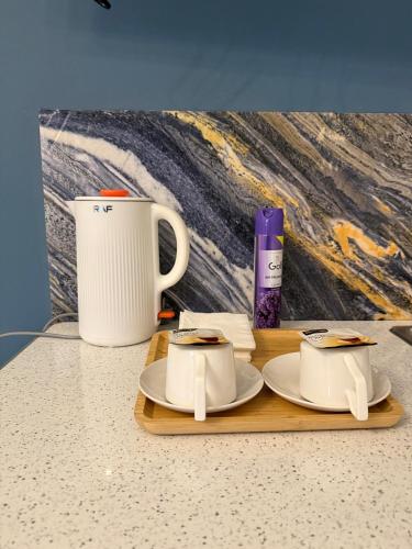 two coffee cups on a wooden tray on a table at Qızıl Farel (Ailəvi İstirahət Mərkəzi) in İsmayıllı