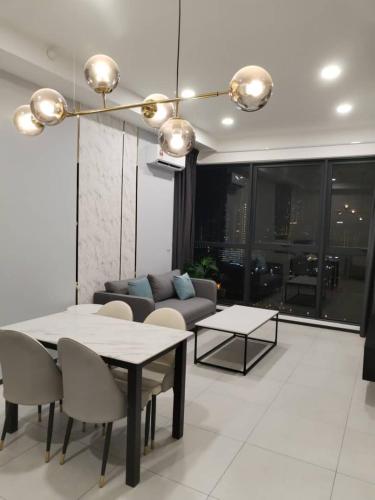 a living room with a table and a couch at Georgetown Ins Cozy Suites 2BR in George Town