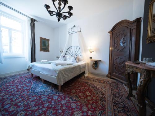 a bedroom with a bed and a chandelier at B&B La Loggia Del Castello in Trento