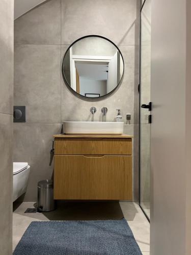 a bathroom with a sink and a mirror at Zero Point Nafpaktos in Nafpaktos