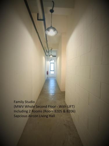 an empty hallway with a light shining in a room at Mwv Family Suite Room in Muar