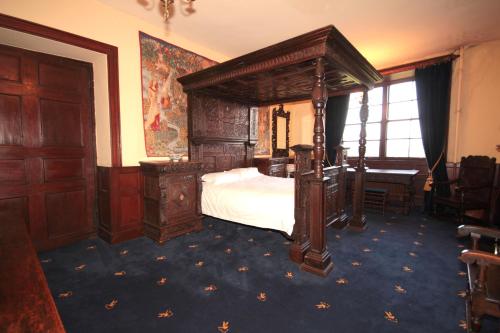a bedroom with a canopy bed and a desk at Appleby Castle in Appleby