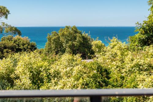 a view of the ocean from a balcony at Dromana Tree House Private Gardens & Ocean Views in Dromana