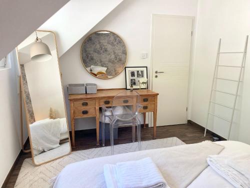 a bedroom with a dressing table and a mirror at Boho Chic Penthouse in Luxembourg