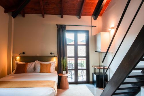 um quarto com uma cama e uma escada com uma janela em Ξενώνας Καλλίστη em Levádeia