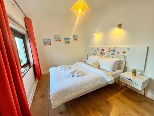 a bedroom with a bed and a window at Happy Sandy Feet in Youghal