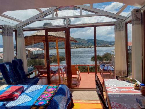 a bedroom with a view of the water at Wiñay UTA lodge in Puno