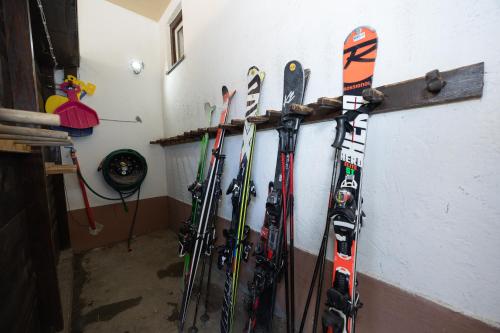 a bunch of skis are hanging on a wall at Pension Appartments Christoph in Westendorf