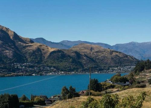 a view of a lake with mountains in the background at Sunbeam Hideaway Kelvin Heights in Queenstown