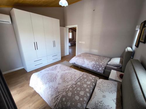 a living room with two beds and a couch at Albanian Traditions Legacy in Durrës