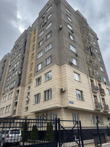 a large building with windows on the side of it at AlaNest Apartment in Bishkek