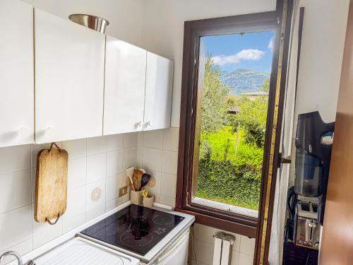 a kitchen with a sink and a window at Casa Boschette in San Felice del Benaco