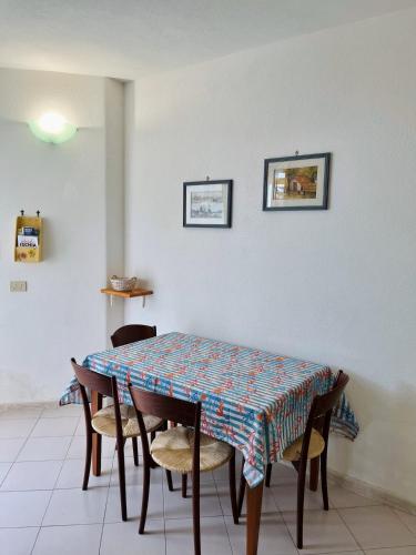 a dining room table with chairs and a patterned table at Ischia Casareccia in Serrara Fontana