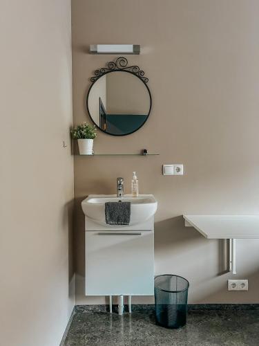 a bathroom with a white sink and a mirror at Guesthouse Reynir in Reynir