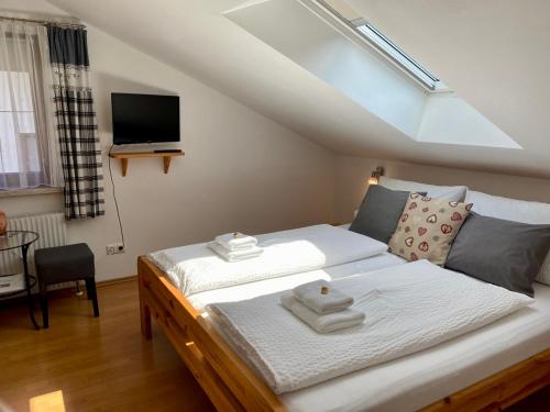 a bedroom with a bed with towels on it at Haus Salzkristall in Obertraun