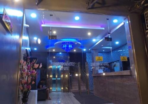 a room with a lobby with blue lights and a door at Grand Diamond Hotels & Suites LTD in Owerri