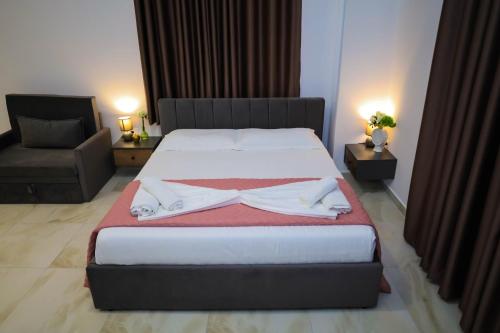 a bedroom with a bed with a robe on it at Tritea Apartments in Golem