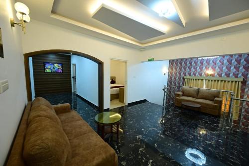 a living room with a couch and a table at North Fort Regency in Cochin