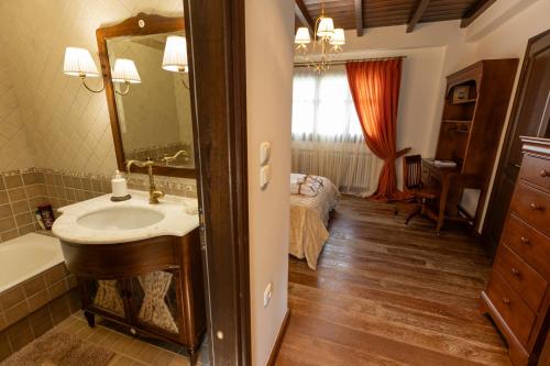 a bathroom with a sink and a mirror and a bed at Tihio Pool Villa & Spa in Tíkhion