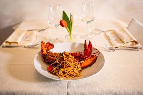 a plate of food on a table with pasta at Hotel Italia in Lerici