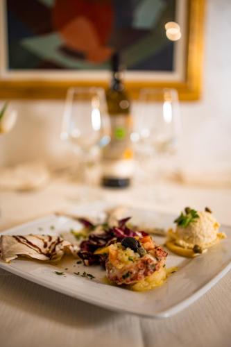 a plate of food sitting on a table at Hotel Italia in Lerici