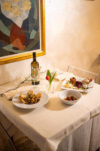 a table with two plates of food and a painting at Hotel Italia in Lerici