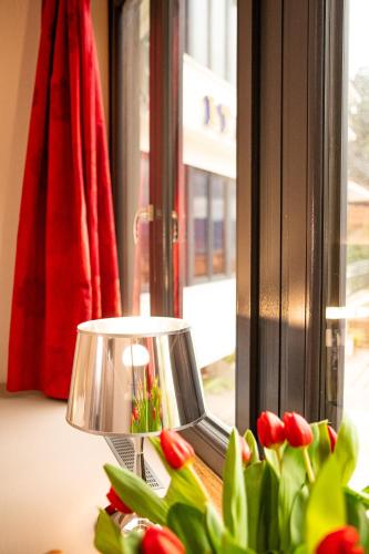 a lamp sitting on a table next to a window at Hotel Italia in Lerici