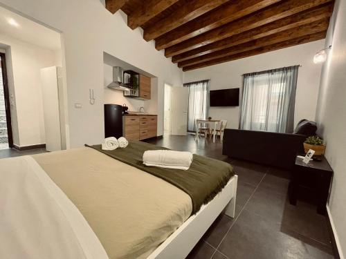 a bedroom with a large bed and a living room at Palermo Inn Collection - Boutique Art Hotel in Palermo