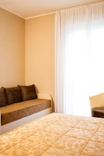 a bedroom with a bed and a window at Hotel Italia in Lerici