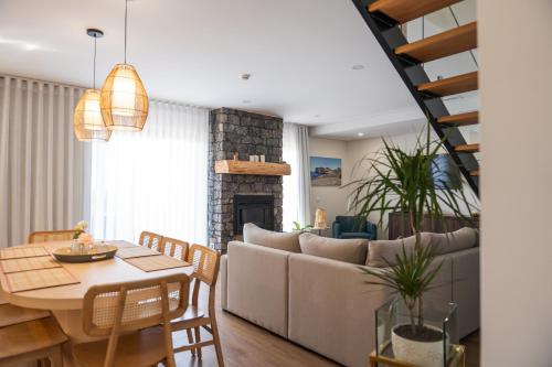 a living room with a couch and a table at Azores Homes Resort & Spa in Ponta Delgada