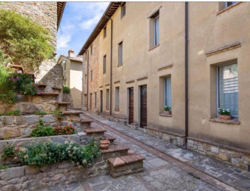 an empty alley with stairs in an old building at Fairytale apartment in 12th century castle - Umbria in Monte lʼAgello