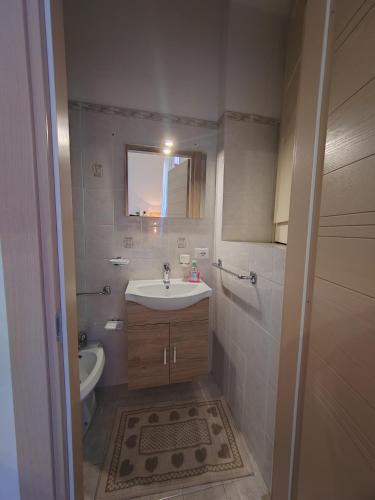 a bathroom with a sink and a tub and a mirror at La casa di Maria in Lipari