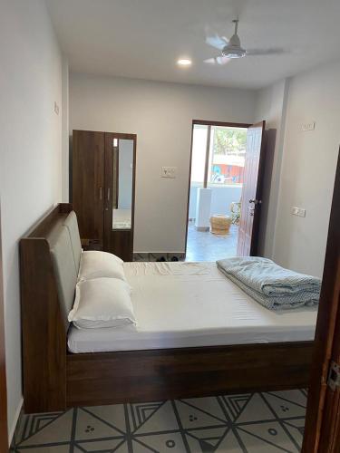 a large bed in a room with at Simple Belle by Half Orangee with Swimming Pool ,Near to Beach -Clubs - Hill Top best for Corporate Bookings-Summer vacation!! in Vagator