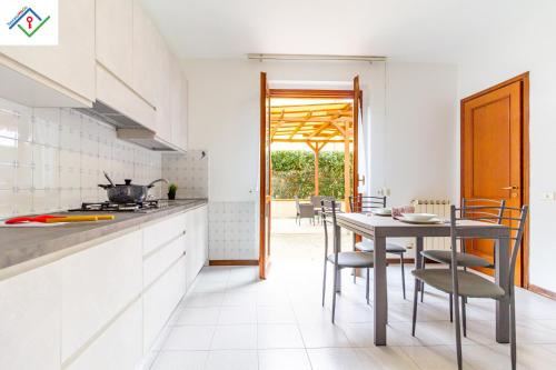a kitchen with a table and chairs in a room at La Casa Di Nico by TuscanyWeGo in Capannori