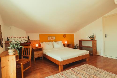 a bedroom with a bed and a table and a chair at New Wellness & Spa Boutique Residence Rovinj in Rovinj