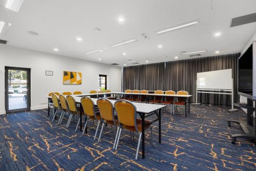 a conference room with a table and chairs at Quest Macquarie Park in Sydney