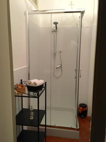 a shower with a glass door in a bathroom at La Maison in Bergamo