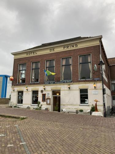 a building with a bird on top of it at IJsselmeerzicht sfeervol appartement aan het strand! Privé parkeerplaats in Makkum