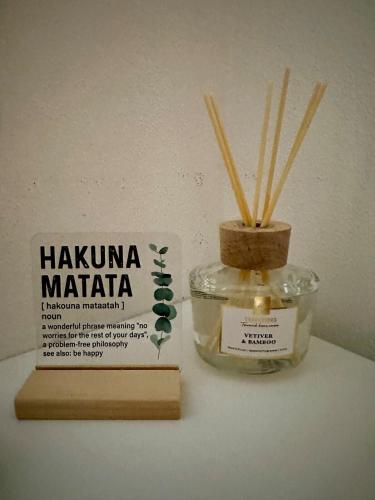 a jar with bamboo sticks in it next to a book at Bali byt s parkovacím místem v centru města in České Budějovice