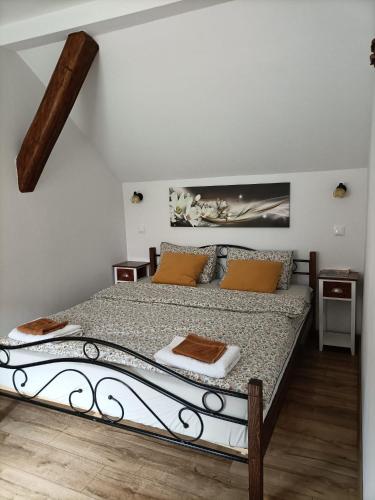a bedroom with a large bed in a room at Apartamenty w Stodole in Krościenko