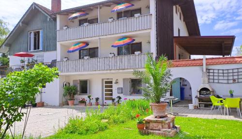a building with umbrellas on the balconies of it at Pension Birkenhof in Hengersberg
