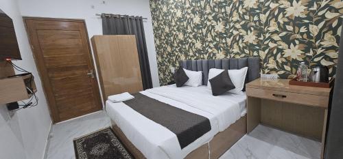 a bedroom with a bed with a floral wallpaper at Hotel Legacy in Prayagraj