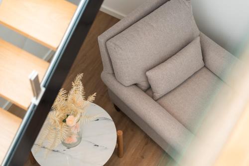 an overhead view of a couch and a table with a chair at Azores Homes Resort & Spa in Ponta Delgada